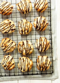 chocolate drizzled cookies on a cooling rack