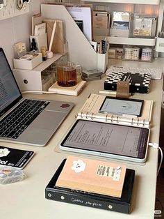 a desk with two laptops and several other items on it