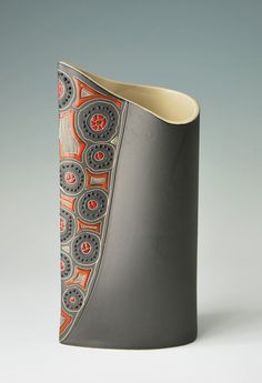 the vase is made out of ceramic and has an intricate design on it's side