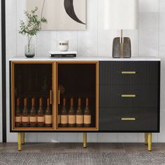 a sideboard with wine bottles in it and a painting on the wall