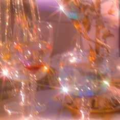 a table topped with lots of shiny glass vases