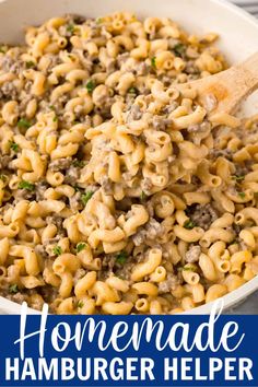 homemade hamburger helper recipe in a white bowl with a wooden spoon and text overlay