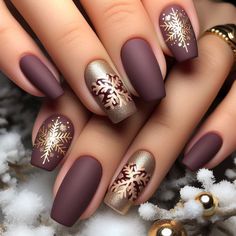 Elegant winter nail art with a matte finish in deep burgundy, adorned with gold snowflake accents Dark Plum Nails With Design, Christmas Nail 2024 Trends, Matte Christmas Nails Holidays, Burgundy Holiday Nails, Christmas Matte Nails, Elegant Christmas Nails Classy Sparkle, Gold Snowflake Nails, Christmas Nails Burgundy, Burgundy Winter Nails