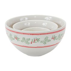 three white bowls with holly designs and red trimmings on the rim, one bowl has