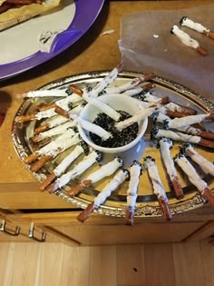 there are many sticks that have been placed in a bowl on the table with other food items