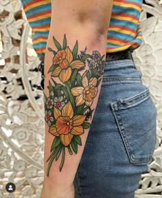 a woman with a flower tattoo on her arm