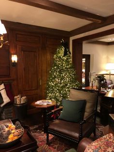 a living room filled with furniture and a christmas tree