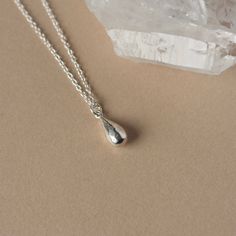 This elegant everyday necklace features a solid sterling silver teardrop charm. The small charm has a glossy polish and some subtle facets that add a bit of extra shine. Measuring 9mm in length and 4mm in width, the petite charm slides smoothly along the sterling silver cable chain for a simple and chic design that goes with everything. The necklace looks great worn solo but it's also a perfect layering piece to pair with others. The necklace is fastened with a sterling silver spring ring clasp and you can choose your desired length from the drop-down menu above.  For more minimalist necklaces www.etsy.com/ca/shop/juliegarland/search?search_query=minimalist+necklace And to return to the store: www.etsy.com/ca/shop/juliegarland Silver Drop Necklace, Silver Necklace Simple, Country Rings, Necklace Simple, Small Charms, Everyday Necklace, Teardrop Necklace, Silver Spring, Layering Necklace