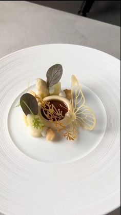 a white plate topped with food on top of a table