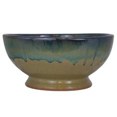 a green and blue bowl sitting on top of a table