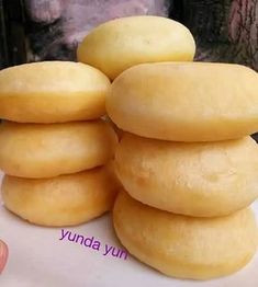 a stack of doughnuts sitting on top of a white plate