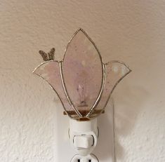 a light switch with a glass flower on it