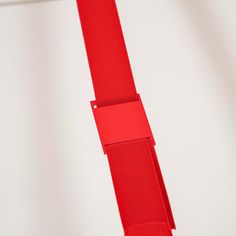 a red piece of paper hanging on a white wall