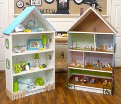 two wooden doll houses sitting on top of a hard wood floor next to each other