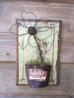 a potted plant hanging on the side of a wooden wall with a sign that says butternut