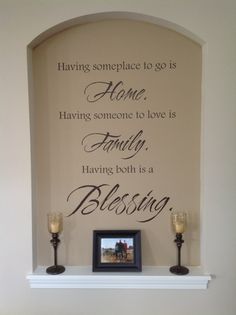 a fireplace mantle with candles and a framed photo