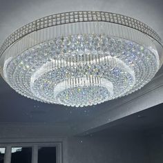 a large crystal chandelier hanging from the ceiling in a room with white walls