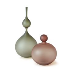 two vases sitting next to each other on a white surface, one is green and the other is brown