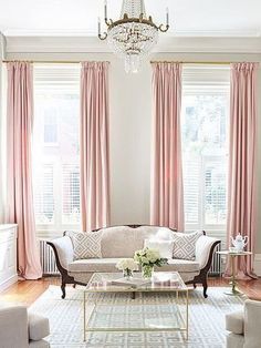 a living room filled with furniture and a chandelier