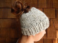 Ponytail Headband, Messy Bun Hat, Knit Pony Tail Hat, Running Headband This hat is hand knit with a soft  wool/acrylic blend yarn in gray.  Perfect when you're wearing your hair in a messy bun or ponytail. Hand wash in cold water and lay flat to dry. To View All KnitOneToo shop items>> https://www.etsy.com/shop/knitonetoo?ref=shop_sugg Follow on Instagram>> @knitonetoo Pony Tail Hat, Ponytail Headband, Slouchy Winter Hat, Ski Headband, Ponytail Hat Crochet, Messy Bun Hat Crochet, Crochet Messy Bun, Cute Buns, Messy Bun Beanie