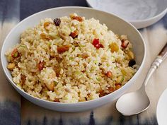 a white bowl filled with rice and nuts