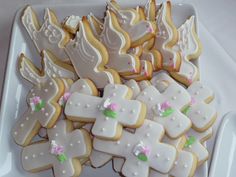 a white plate topped with lots of decorated cookies