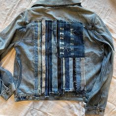 an old jean jacket that has been altered to look like the american flag