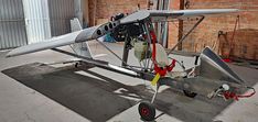 an airplane is parked in a building with brick walls