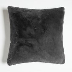 a black pillow with a cat's face on the front and back of it