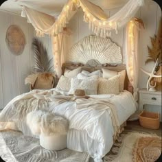 a white bed with lots of pillows and blankets