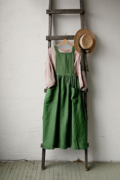 Pinafore dress with flutter sleeves is made from 100% soft and washed linen. Details: - Composition: 100% Oeko-Tex certified linen - Colour: apple green - Cross back - Length - 124 cm (49 inches) - Adjustable with buttons - Elastic Waist - Medium weight linen - Linen care: machine wash gentle; tumble dry low, ironing optional - The price is for one pinafore dress, other pictured items are not included Green Linen Dresses For Fall, Green Linen Dress With Pockets, Spring Green Linen Dress With Pockets, Green Linen Dress With Pockets For Spring, Green Relaxed Fit Linen Dress With Pockets, Summer Cotton Pinafore Dress With Ruffles, Green Relaxed Fit Linen Dress, Green Cotton Cottagecore Dress, Cottagecore Green Cotton Dress