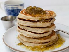 a stack of pancakes sitting on top of a white plate