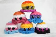 a group of crocheted hats sitting on top of each other