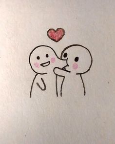 a drawing of two people holding each other with a heart above their heads on a piece of paper