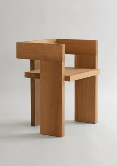 a wooden table and chair sitting on top of a white floor next to each other