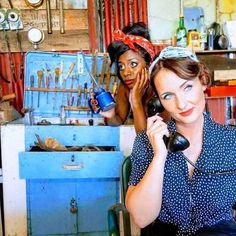 two women are talking on telephones in a room full of tools and other things