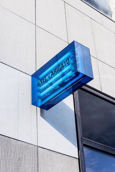 a blue sign on the side of a building