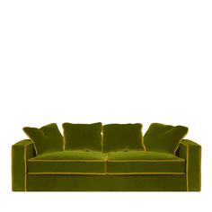 a green couch with two pillows on the back and yellow trimmings around it