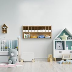 a baby's room with white walls and wooden shelves filled with toys, including a teddy bear