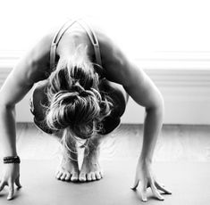 a woman is doing a handstand on the floor