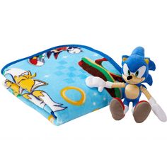 sonic the hedge plush toy laying on top of a blue and yellow pillow with an image of