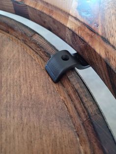 the back end of a wooden barrel with a black latch on it's side