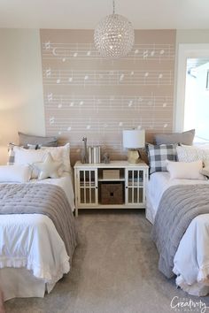 two beds in a room with musical notes on the wall