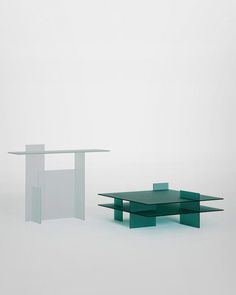 two glass tables sitting next to each other