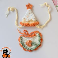 a crocheted hat and bib on a table