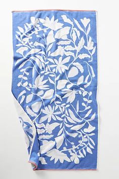 a blue and white towel with leaves on it