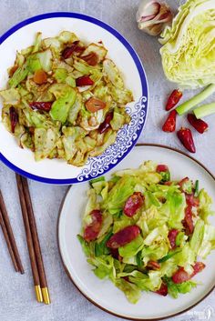 two plates filled with salad next to chopsticks