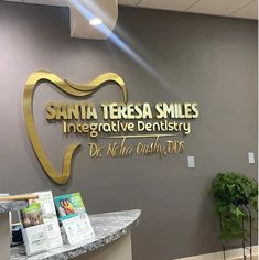 there is a dental office sign that says santa teresa smiles integrative dentists