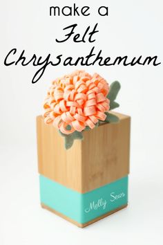 there is a small wooden box with flowers in it that says make a felt chrysanthemum