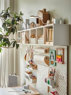 a room with some shelves on the wall and various objects hanging from it's sides